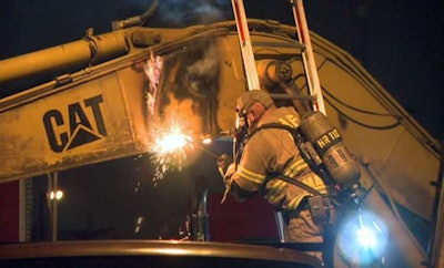 Houston firefighters use a blowtorch to cut open an excavator after being alerted to marijuana being smuggled inside the machine’s arm. Credit: KHOU TV