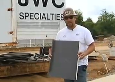 Project superintendent Jared Johnson with a sample of the roofing he helped recover. Credit: WSMV TV
