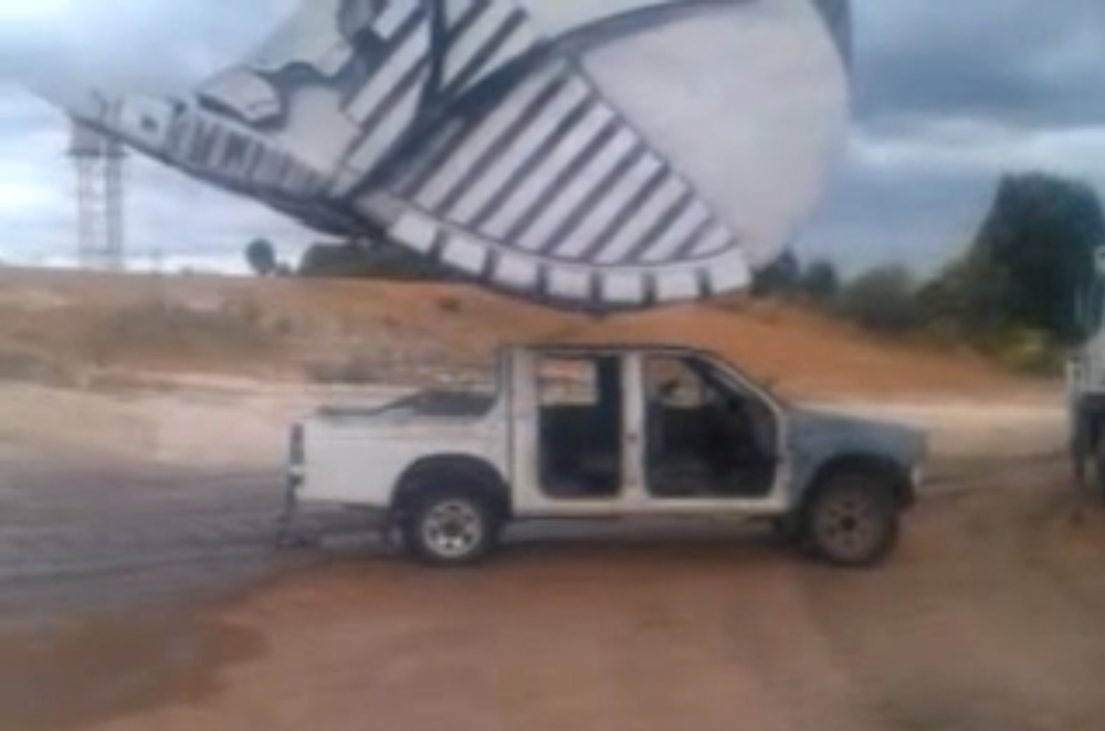 Mining excavator flattens pickup