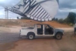 Mining excavator flattens pickup
