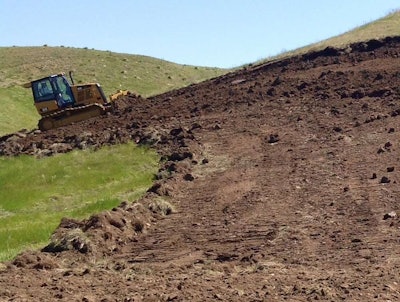 A Cat dozer can be seen perfecting a turn in a new TORC course being built in Sturgis, South Dakota.