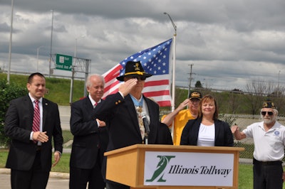 Allen J. Lynch returns a salute from veterans gathered in the audience during the ceremony. (Photo courtesy of the Illinois Tollway)
