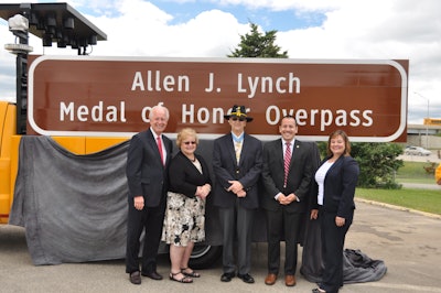 (left to right) State Sen. Terry Link, former State Rep. JoAnn Osmond, Allen J. Lynch, Illinois Department of Veterans’ Affairs Assistant Director Rodrigo Garcia and Illinois Tollway Executive Director Kristi Lafleur stand in front of the new sign.