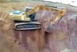 Excavator topples off bench