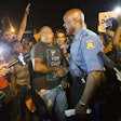 Missouri Highway Patrol Captain and newly appointed head of security in Ferguson Ron Johnson speaks with protesters. Credit: Mario Anzuoni/Reuters