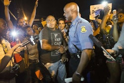 Missouri Highway Patrol Captain and newly appointed head of security in Ferguson Ron Johnson speaks with protesters. Credit: Mario Anzuoni/Reuters