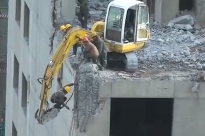 Excavator hammer dangles worker demolition