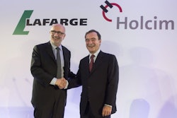 Holcim President Rolf Soiron, left, and Lafarge CEO Bruno Lafont, right, announce their planned merger on April 7, 2014.