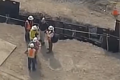 Officials gathered near the ditch where a construction worker was fatally electrocuted in Edmonds, Washington. Credit: KIRO TV