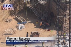 A stretcher basket is lowered into a pit as fire crews attend to a construction worker after he suffered a heart attack. Credit: KTRK TV Houston