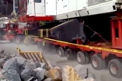 crane shoves truck down hill