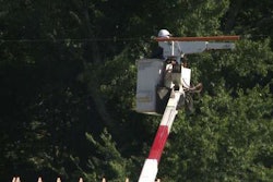 An electric co-op worker examines the power line above a home construction site where a construction worker was killed. Credit: CBS 6 TV
