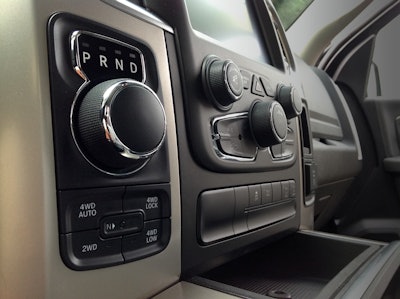 Shifting is done via a large dial knob, while selecting drive mode is done with push buttons below.