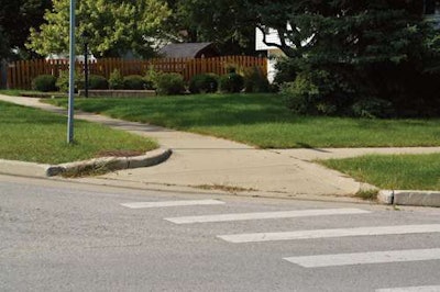 This ramp is present with friction treatment, but it lacks tactile bumps.