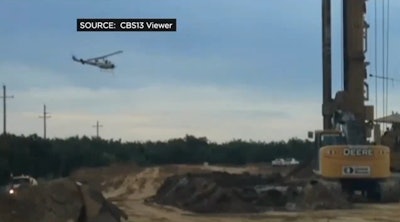 A still from a video shot by a construction worker of a helicopter spraying pesticide near a jobsite in Sacramento.