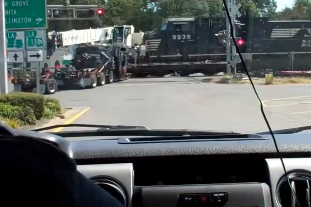 train hits truck towing crane