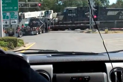 train hits truck towing crane