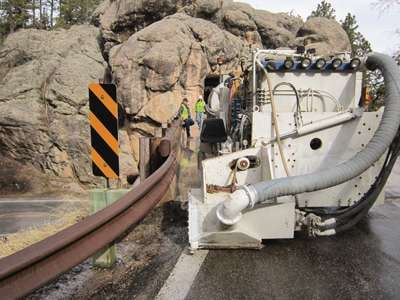 Working on the narrow Iron Mountain Road in South Dakota, two grinder operators were required to control the accuracy of the grinding process.