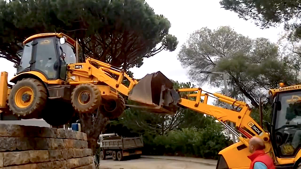 Backhoe buddy system off wall