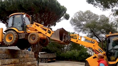 Backhoe buddy system off wall