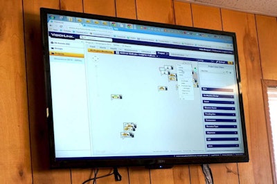 A monitor in the office at the connected jobsite shows the position and status of each machine in the fleet using Trimble’s VisionLink software.