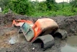 Excavator stuck boom deep in mud
