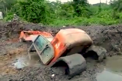 Excavator stuck boom deep in mud