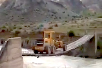 Motor grader crosses rope bridge