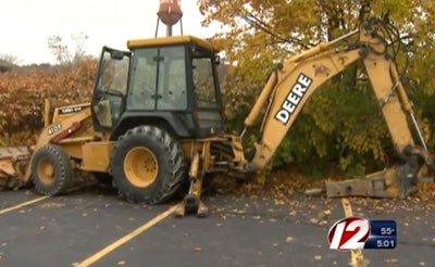 A worker in Rhode Island was killed Wednesday by a piece of equipment that “fell on him.” Investigators spent time examining this backhoe. Credit: WPRI TV 12