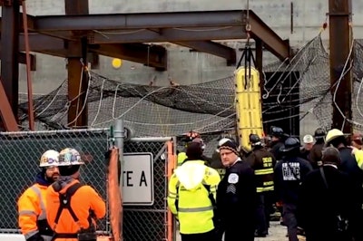 In this still from Chicago Tribune video, a worker is lifted from a 10-foot hole after surviving the collapse of a steel beam he was working on top of.