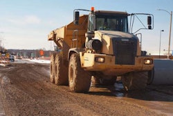An articulated dump truck hauls fill for the new southbound ramps on a jobsite for the new Milwaukee Zoo interchange. Credit: WisDOT