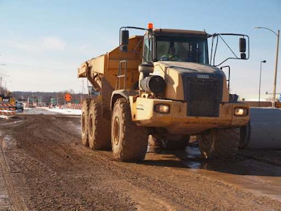 An articulated dump truck hauls fill for the new southbound ramps on a jobsite for the new Milwaukee Zoo interchange. Credit: WisDOT