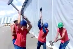 Workers sledgehammering stake
