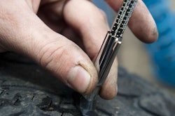 Measuring tire tread depth on light truck tire.