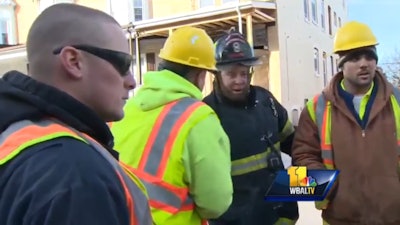 In this still of a report from WBAL TV, Baltimore firefighters thank a group of construction workers for their heroism in saving a man and two children from a row house fire Tuesday afternoon.