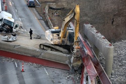 Beams rest atop an excavator following a pancake collapse of an overpass being prepared for demolition in Cincinnati. Credit: Liz Dufour/Cincinnati Enquirer