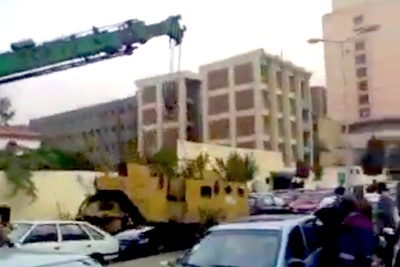 Crane drops roller on top of car