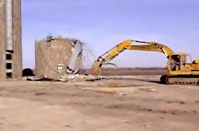 Excavator yanks down silo