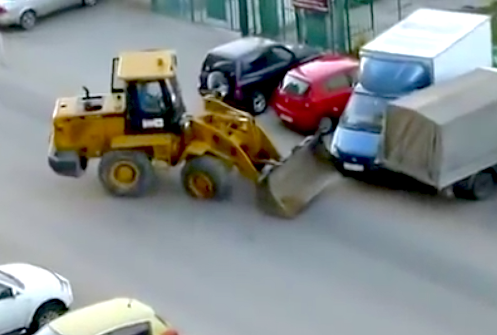drunk man wheel loader parked cars