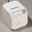 The messageQube, a small, wireless desktop printer that receives text and photo messages from the jobsite.