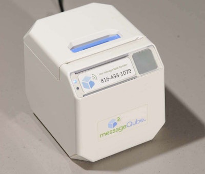 The messageQube, a small, wireless desktop printer that receives text and photo messages from the jobsite.