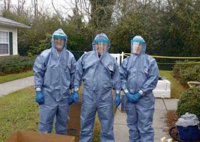 Hayden workers suited up for crime scene cleanup. Credit: Melonie Flomer/Daily Journal