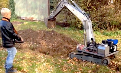 Kid with RC excavator digging trench