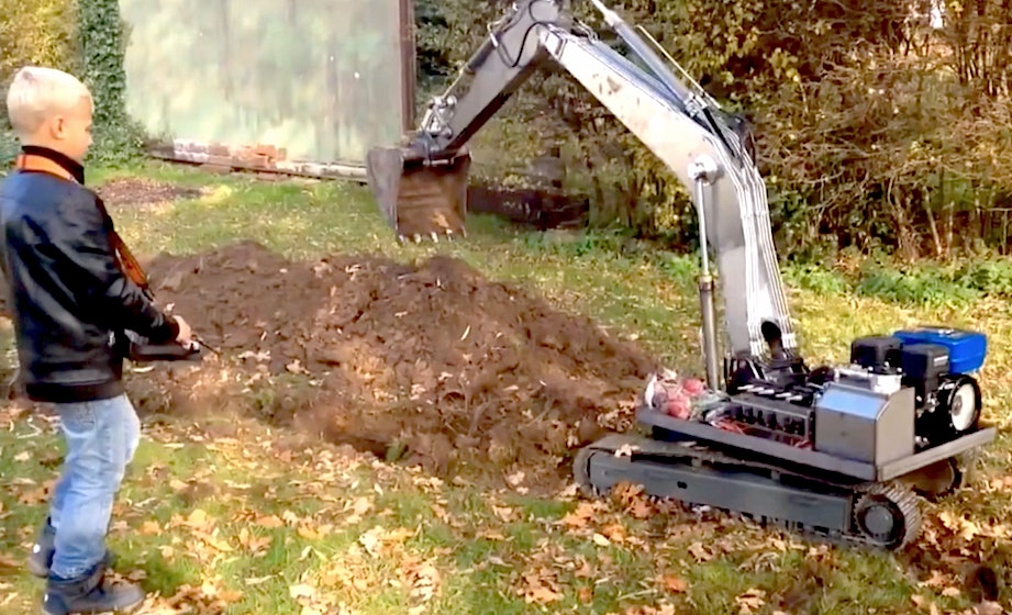 This kid digging a trench with a giant RC excavator will make you question your childhood happiness