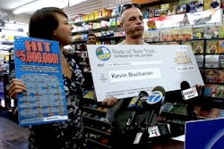 In this still from USA Today video, construction worker Michael Buchanan reacts after being awarded his check after winning a $5 million prize in the New York lottery.