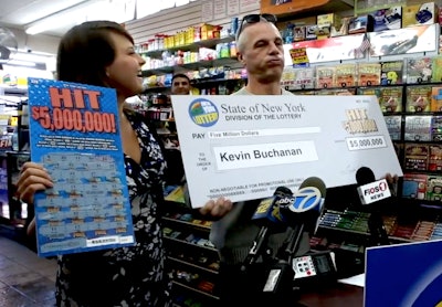 In this still from USA Today video, construction worker Michael Buchanan reacts after being awarded his check after winning a $5 million prize in the New York lottery.