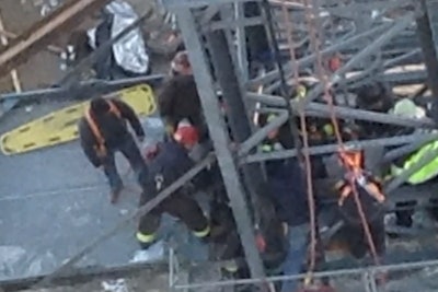 In this still from ABC 7, rescue workers in Chicago respond to a jobsite where a part of a crane fell atop a worker.