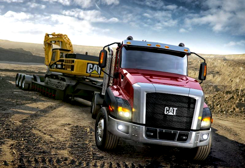 Caterpillar truck hauling Cat exacavator