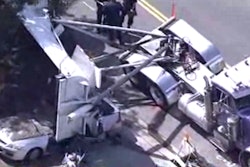 A still from KPIX shows the overturned trailer atop the car.