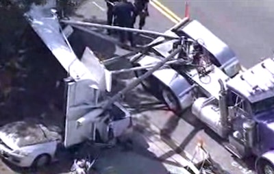 A still from KPIX shows the overturned trailer atop the car.